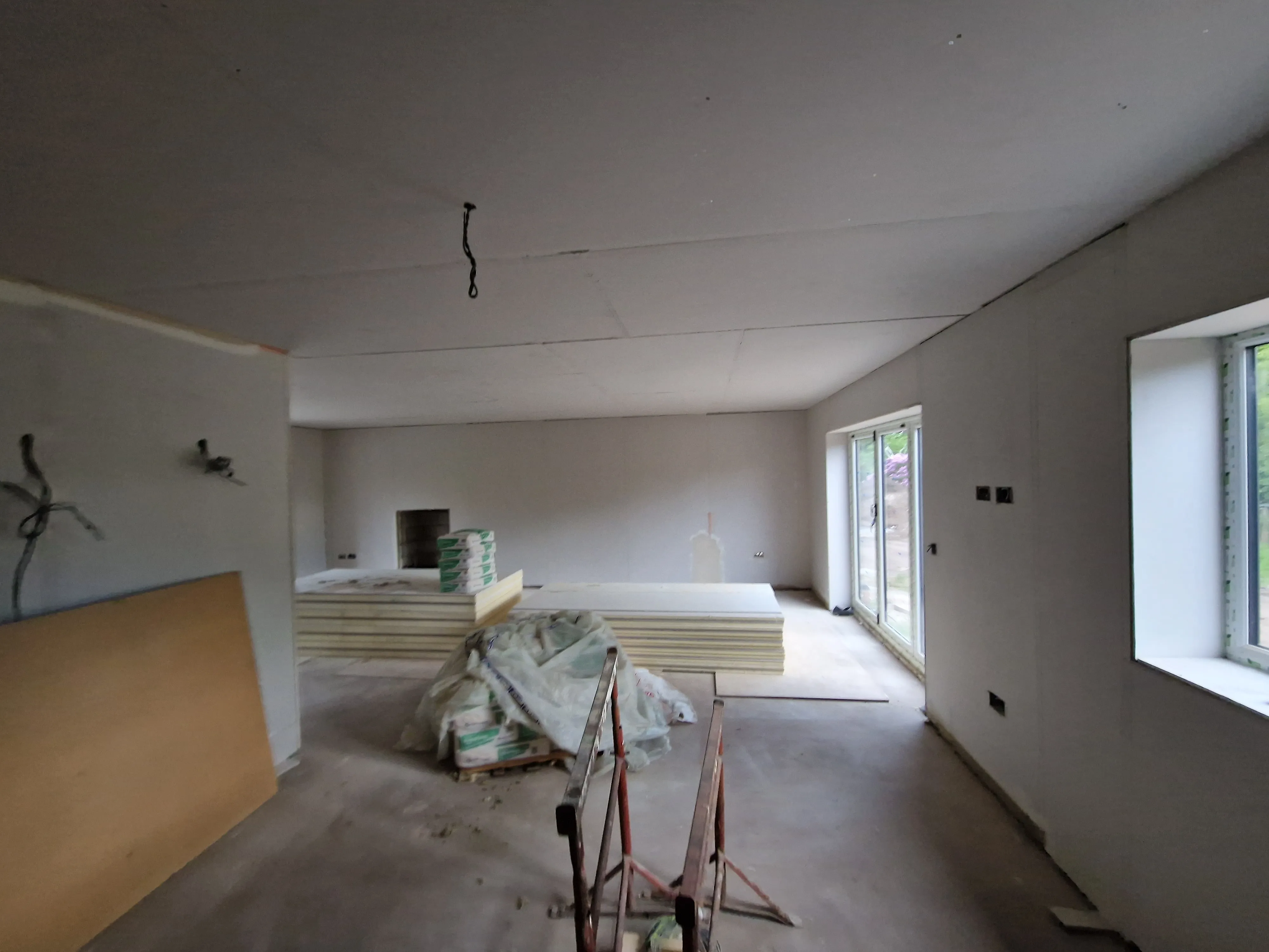 A room with a lot of construction materials on the floor.