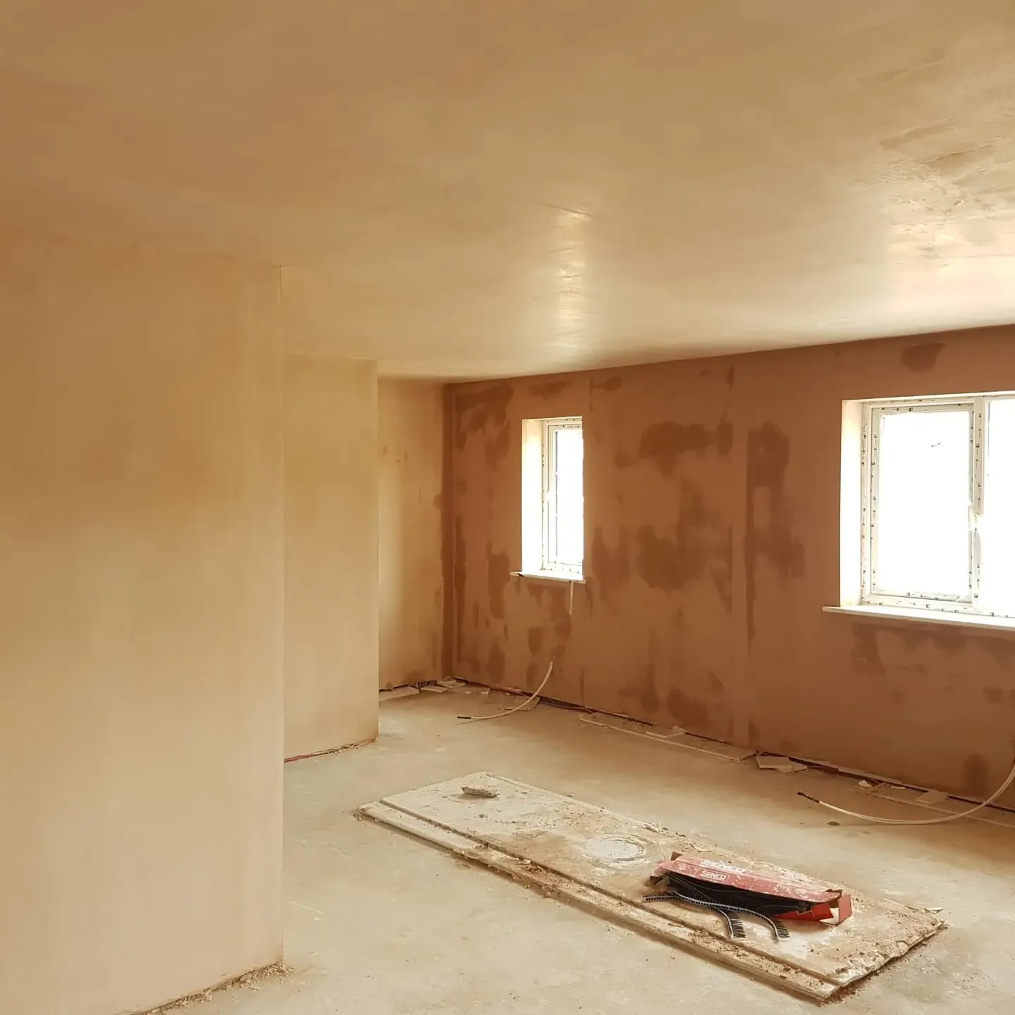 A room that is under construction with a window.
