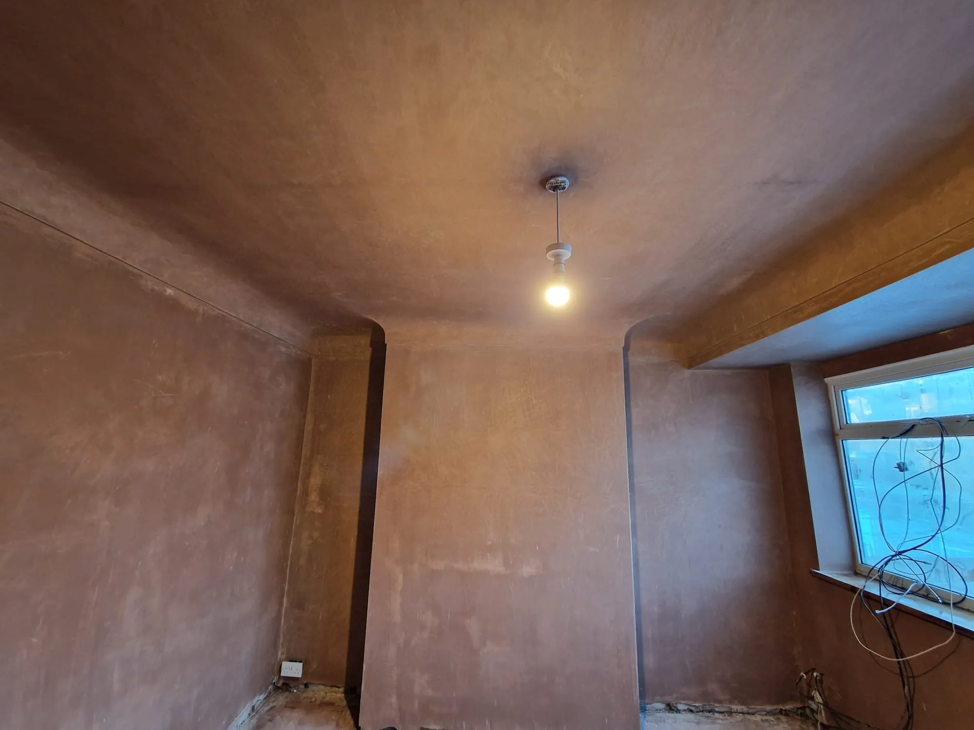 A room with a window and a light in it.