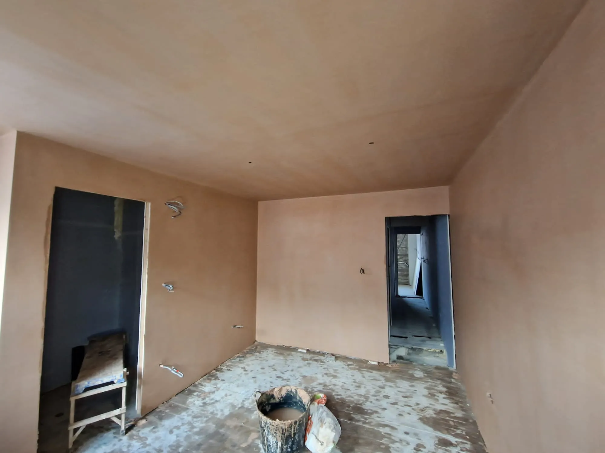 A room with a chair and a mirror in it.