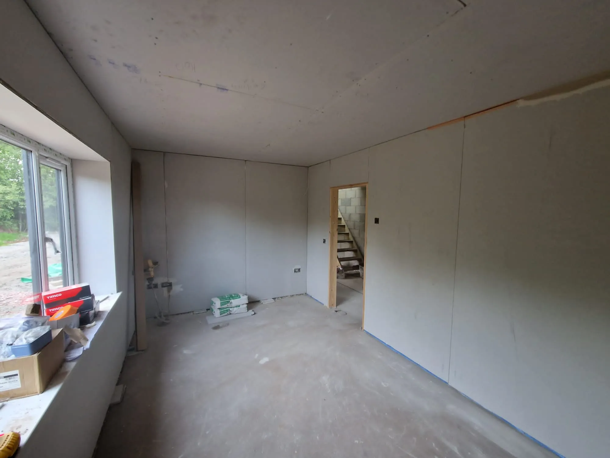 A room that is being remodeled with white walls.